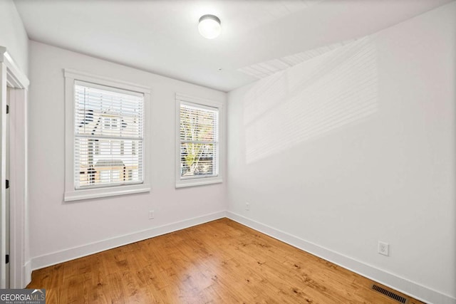 empty room with hardwood / wood-style floors