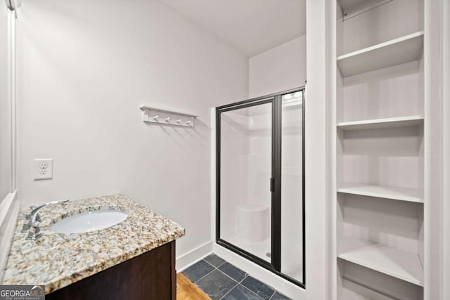 bathroom with vanity, tile patterned flooring, and a shower with door