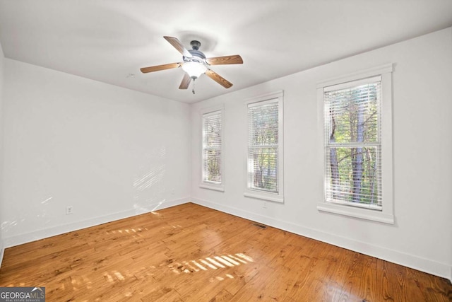 unfurnished room with ceiling fan and hardwood / wood-style floors