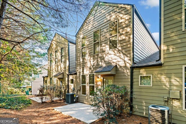 rear view of house with cooling unit and a patio area