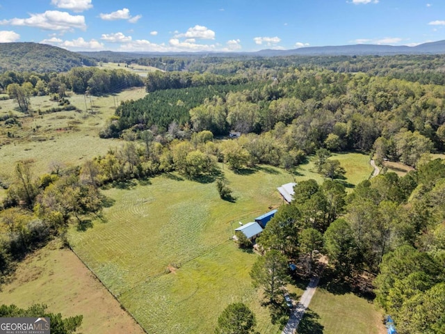 birds eye view of property featuring a mountain view and a rural view