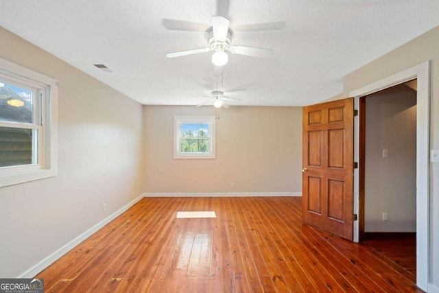 unfurnished room with ceiling fan and wood-type flooring