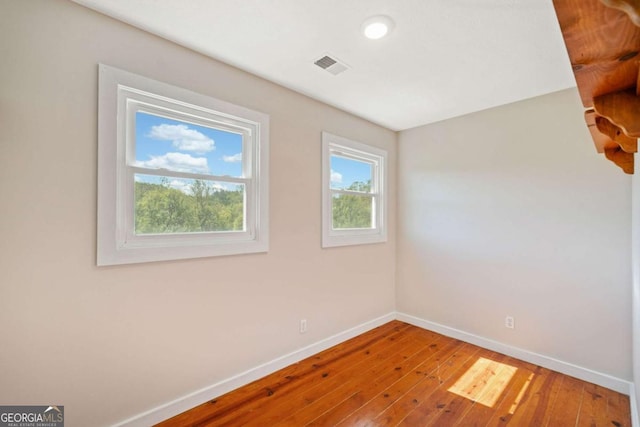 spare room featuring hardwood / wood-style flooring