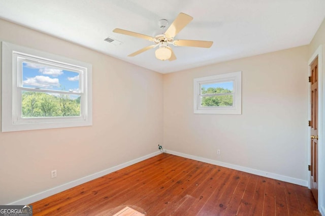 unfurnished room with hardwood / wood-style floors and ceiling fan