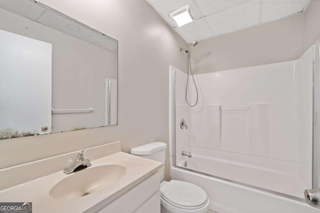 full bathroom featuring vanity, toilet, shower / bath combination, and a drop ceiling