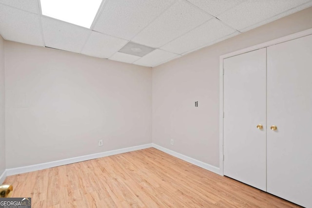 interior space featuring hardwood / wood-style flooring and a drop ceiling