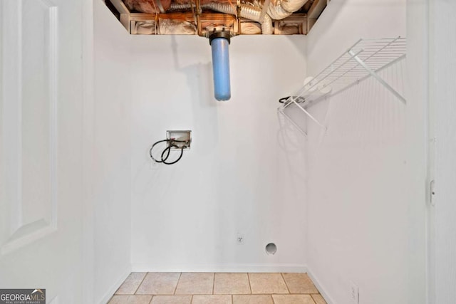 washroom with light tile patterned flooring, hookup for a washing machine, and electric dryer hookup