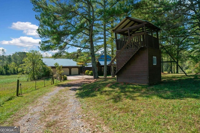 view of side of home featuring a garage and a yard