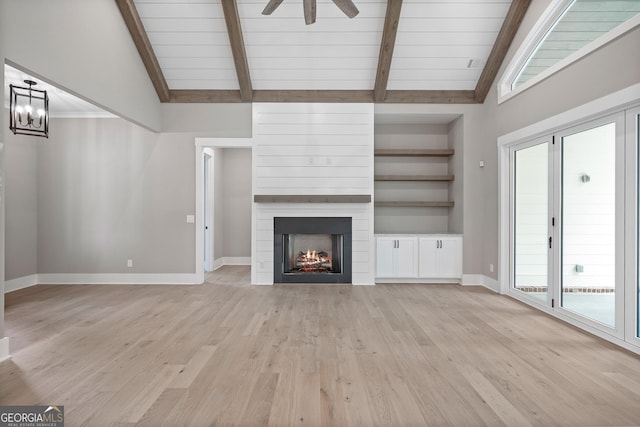 unfurnished living room with light wood-style flooring, a fireplace, and vaulted ceiling with beams