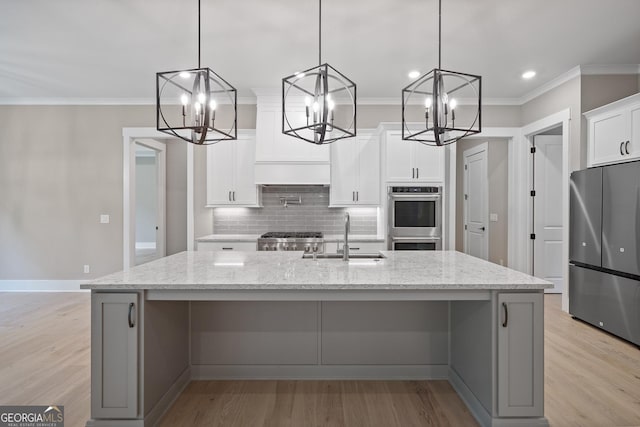 kitchen featuring a sink, stainless steel appliances, backsplash, and ornamental molding