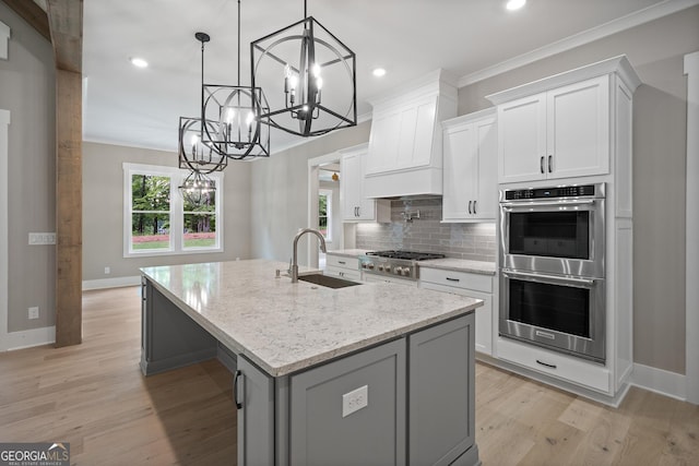 kitchen featuring a sink, stainless steel appliances, tasteful backsplash, and crown molding