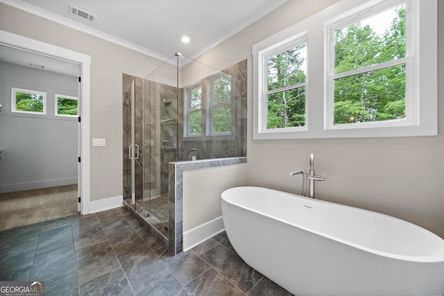 full bath with visible vents, baseboards, a freestanding bath, ornamental molding, and a stall shower