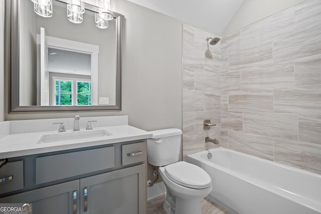 full bath featuring a chandelier, shower / washtub combination, toilet, vaulted ceiling, and vanity