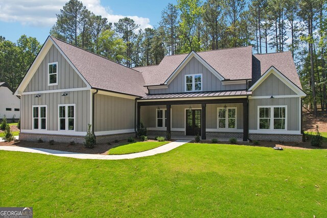 rear view of property featuring a lawn and a patio area