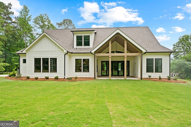 back of property featuring a patio, a lawn, board and batten siding, and a shingled roof