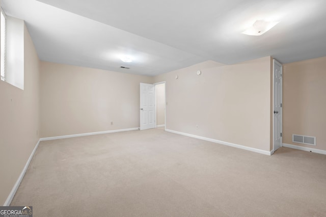 basement featuring light colored carpet