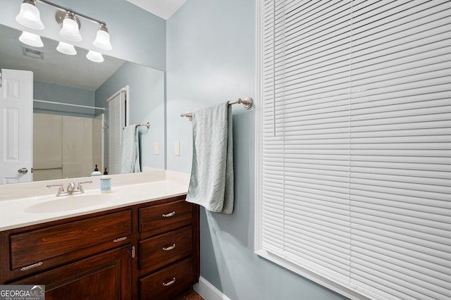 bathroom featuring vanity and a shower