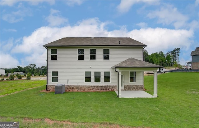 rear view of house featuring a yard, central AC, and a patio