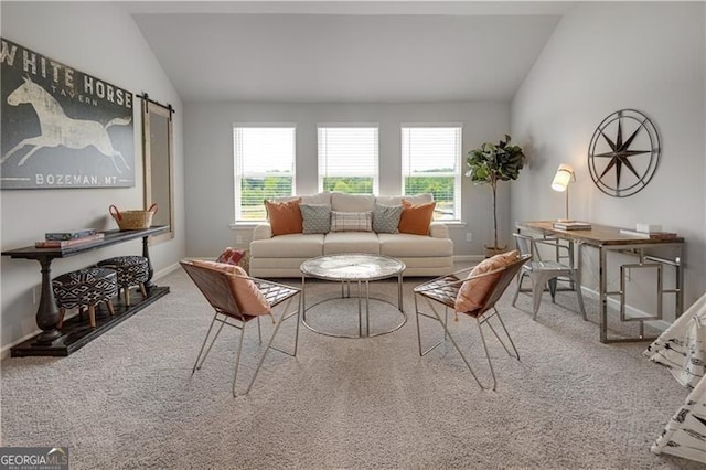 living room with lofted ceiling, carpet flooring, and plenty of natural light