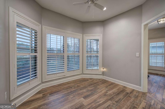 empty room with hardwood / wood-style floors and ceiling fan