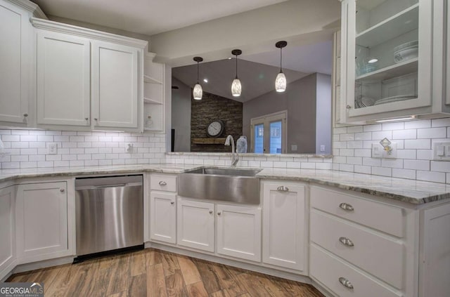 kitchen with sink, white cabinetry, light stone counters, dishwasher, and decorative backsplash