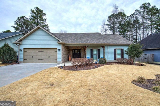 single story home featuring a garage and a front yard