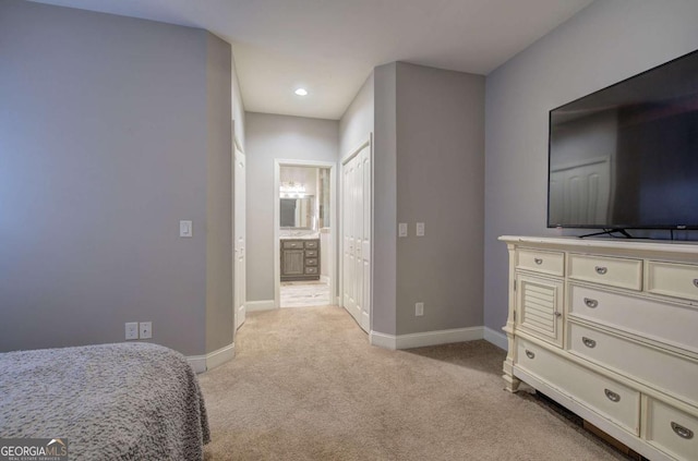 carpeted bedroom featuring connected bathroom and a closet