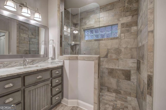 bathroom featuring vanity and a tile shower