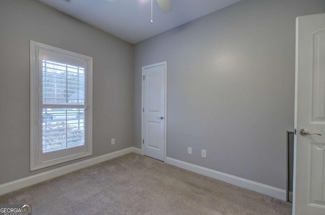 carpeted empty room with ceiling fan