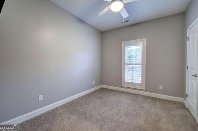 unfurnished room with light colored carpet and ceiling fan