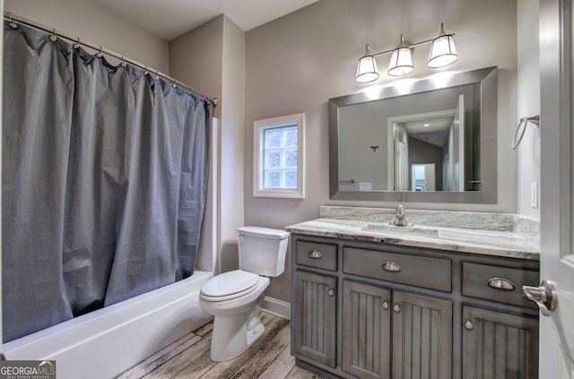 full bathroom with shower / tub combo with curtain, vanity, and toilet