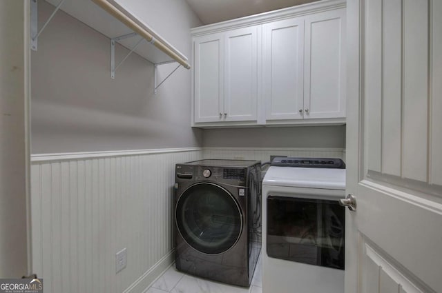 laundry area featuring cabinets and washing machine and dryer