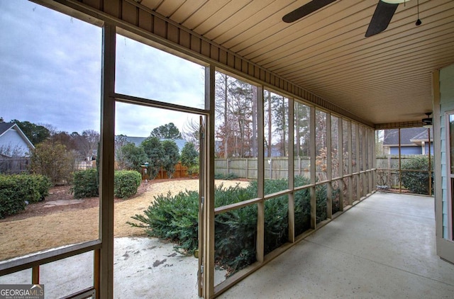 unfurnished sunroom with ceiling fan