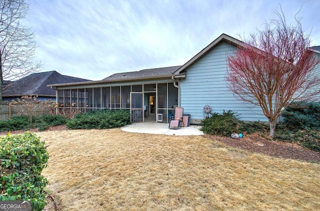 back of house with a sunroom, a yard, and a patio area