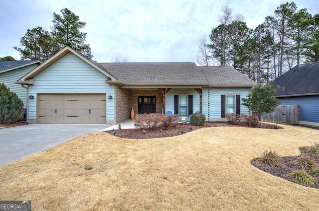 ranch-style house featuring a garage and a front lawn