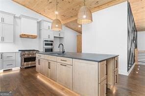 kitchen with pendant lighting, sink, white cabinetry, stainless steel appliances, and dark hardwood / wood-style flooring