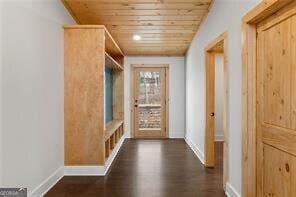 mudroom featuring dark wood-type flooring and wooden ceiling