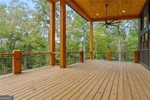 wooden deck featuring ceiling fan