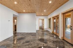 unfurnished room with wooden ceiling and french doors