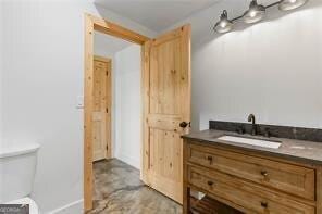 bathroom featuring vanity and toilet