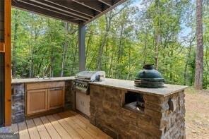 wooden deck with an outdoor kitchen and grilling area