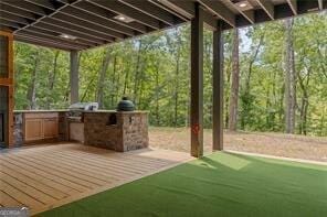 view of patio featuring a wooden deck, an outdoor kitchen, and grilling area