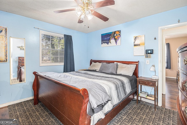 bedroom with dark wood-type flooring and ceiling fan