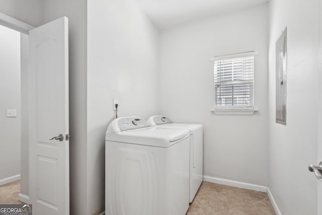 clothes washing area featuring washing machine and dryer and light tile patterned floors