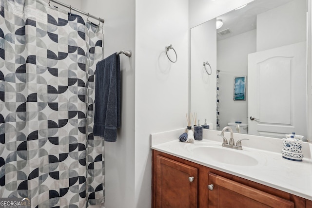 bathroom with walk in shower and vanity