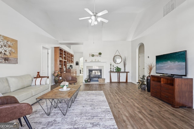 living room featuring ceiling fan, hardwood / wood-style floors, and high vaulted ceiling