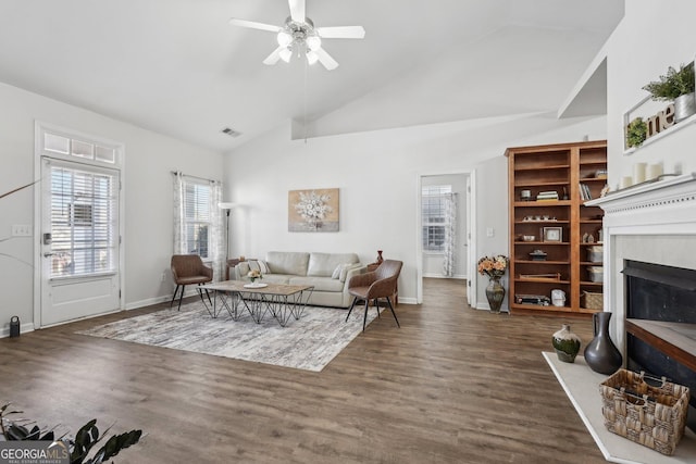 living room with ceiling fan, dark hardwood / wood-style floors, and high vaulted ceiling