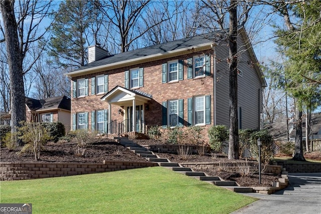 colonial inspired home with a front yard