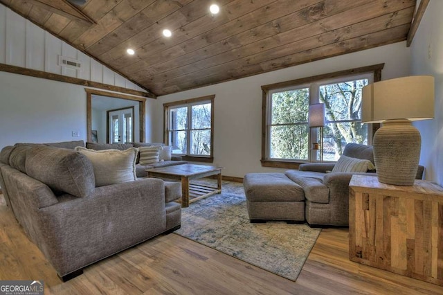 living room with wood ceiling, a healthy amount of sunlight, and light hardwood / wood-style flooring