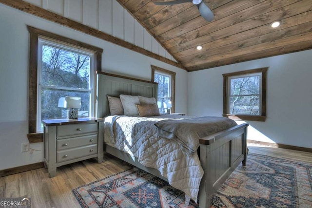 bedroom featuring light hardwood / wood-style flooring, wooden ceiling, ceiling fan, and vaulted ceiling